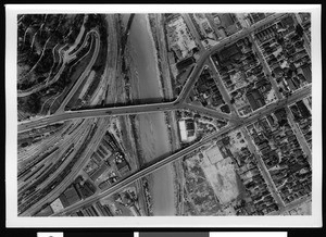 Aerial view of the swollen Los Angeles River partly showing Elysian Park and the Bullring railroad, Los Angeles,, 1938