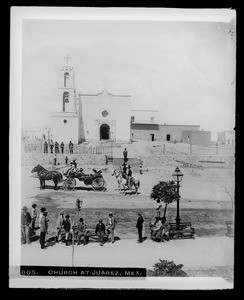 A group of people on the sidewalk across the street from the church in Juarez, Paso del Norte, Mexico, ca.1905