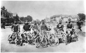 Six riders of the Los Angeles Bicycle Club posing with their flower decorated bicycles at the Fiesta de Los Angeles, ca.1887
