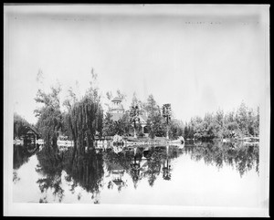 View of Elias Jackson "Lucky" Baldwin's Rancho cottage club house from across the lake, ca.1887