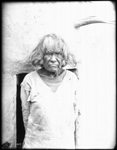 Old Hopi Indian man standing outside, ca.1900