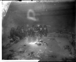 Hopi Antelope priests in a kiva, an underground club hall, preparing for the snake dance in an Indian religious ritual, Oraibi, ca.1900