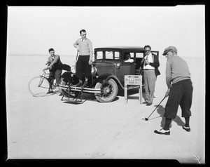 Men golfing near an automobile