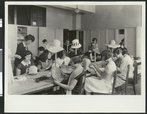 Female garment workers making hats, ca.1925