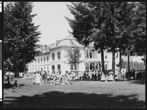 Group of Indian girls posing in front of their dormitory at the Indian Training School in Chemawa, Oregon, ca.1900