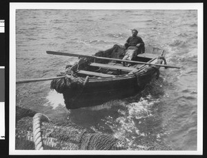 Man in a fishing boat, ca.1910
