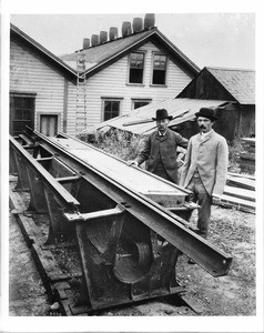 Two men at cable car track manufacturing plant, ca.1890