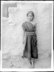 Young Hopi Indian girl standing outside, Oraibi, Arizona, ca.1900