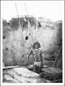 Antelope priest descending into kiva at pueblo of Walpi, Arizona, 1897