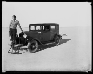 Golfer standing on the front bumper of an automobile