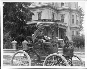 A man driving on Spring Street in front of the Van Nuys family residence, ca.1902