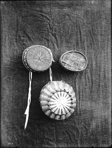 Three unidentified Indian baskets on display, ca.1900