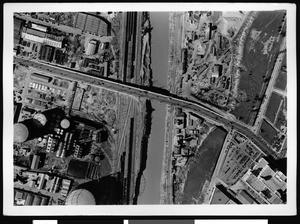 Aerial view of Los Angeles, showing a swollen river near a railroad yard, 1938