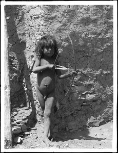 Naked Hopi Indian boy with bow and arrow, 1903