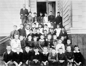 Grammar school children posing with their teachers on the steps of their school in Monrovia, Los Angeles, ca.1889-1890