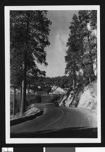 Automobile on a road bordering Lake Arrowhead, ca.1950