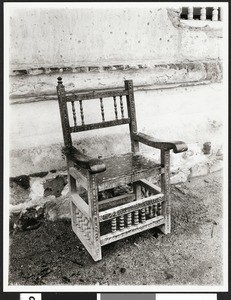 View of Confessional chair apparently against exterior of the Mission San Xavier del Bac, ca.1900/1910