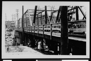 Pedestrians crossing a wooden viaduct in Los Angeles