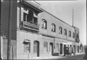 Eastward view of Marchessault Street in Los Angeles's Chinatown, showing a laundry truck, November 1933