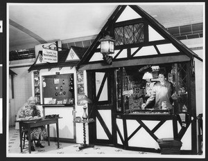 Booths at a Chamber of Commerce exhibit, where you can buy pressed flowers or antiques, ca.1930