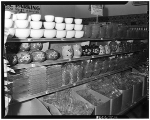 Shelves holding pottery and glassware in a supermarket