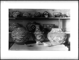 Collection of about twenty pieces of Pueblo Indian pottery on display, New Mexico, ca.1900