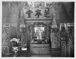 Interior of a Chinese store decorated for the New Year's celebration, ca.1900