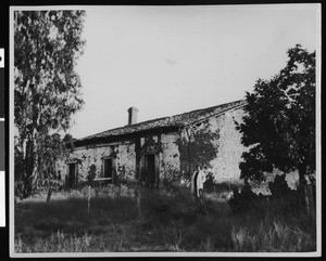 Woman outside the Pedro Estrada adobe on Rancho Asuncion, ca.1900