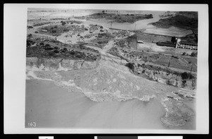 Aerial view of flood in Azusa, showing San Gabriel Railroad suspended over cliff, California, 1938