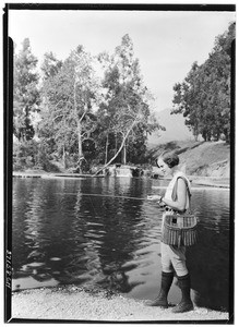 Jewell Teegardin holding a fishing pole at Rainbow Angling Club, Azusa, October 1930