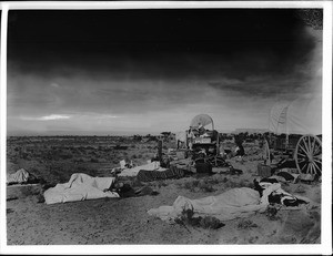 Group of people sleeping at dawn at the campsite of Dr. George Wharton James near the village of Shonguapavi, ca.1900