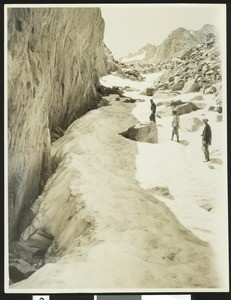 Three mountaineers making their way up a snow pass