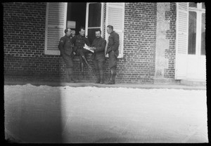 View of four soldiers examining a map during World War I, ca.1916