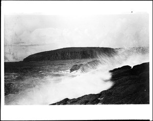 Waves crashing onto the rocks at Abalone Point in Laguna Beach, ca.1910