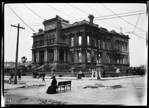 Flood damage shown in street and large mansion