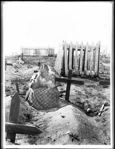 Ramona kneeling at the grave of Alesandro in the cemetery on the Coahuilla Indian Reservation, ca.1905