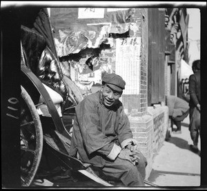 Portrait of a rickshaw driver laughing, China, ca.1900