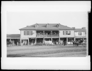 Exterior view of two-storied Chinese restaurant (Lugo residence) in disrepair on the east side of the Plaza, ca.1886