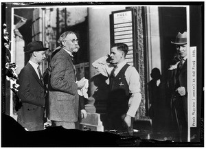 Frank Wiggins outside the Los Angeles Chamber of Commerce during a fire, 1921