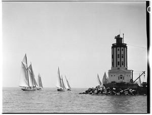 Yachts sailing around the lighthouse in Los Angeles Harbor