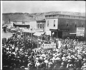 A street scene of people boosting for tickets to the "Grand Ball" during the boom days at the mines, Goldfield, Nevada, ca.1905