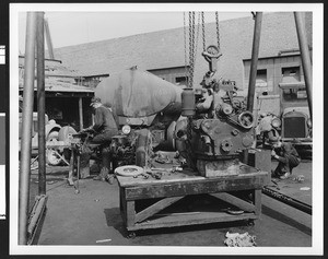 Exterior view of what appears to be a truck repair garage, ca.1925