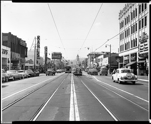 View of Hollywood Boulevard at Wilcox Avenue, showing automobiles and Karl's Shoes, 1953