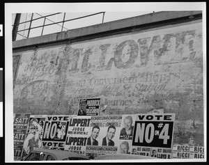 Old Mount Lowe billboard papered over with new election signs, Altadena