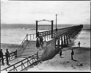 View of Ocean Park pier looking out to sea with a few people strolling, ca.1897