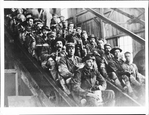 A group of miners assembled on inclined tram ready to descend to 2300-ft level of gold mine, Grass Valley, California, before 1906
