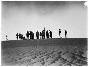 Funeral atop a sandy hill