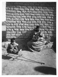 Pima Indian woman basket maker with her small son, Gila Crossing, ca.1900