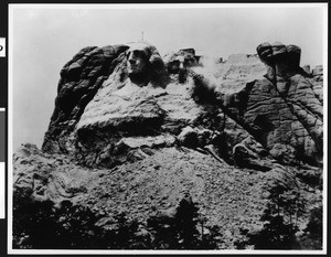 View of an unfinished Mount Rushmore, showing only George Washington, in Black Hills, South Dakota, 1940-1950