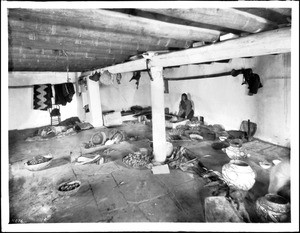 Interior of a Zuni pueblo home showing the use of pottery, ca.1898